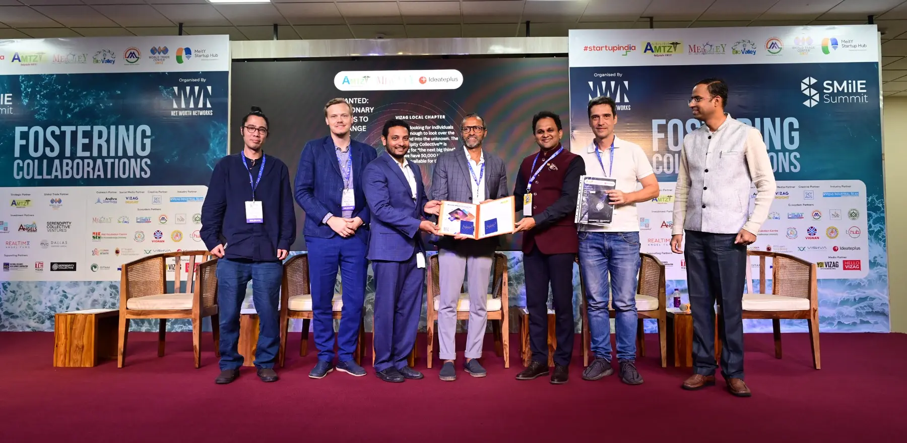 Representatives mark an MoU signing at SMilE Summit