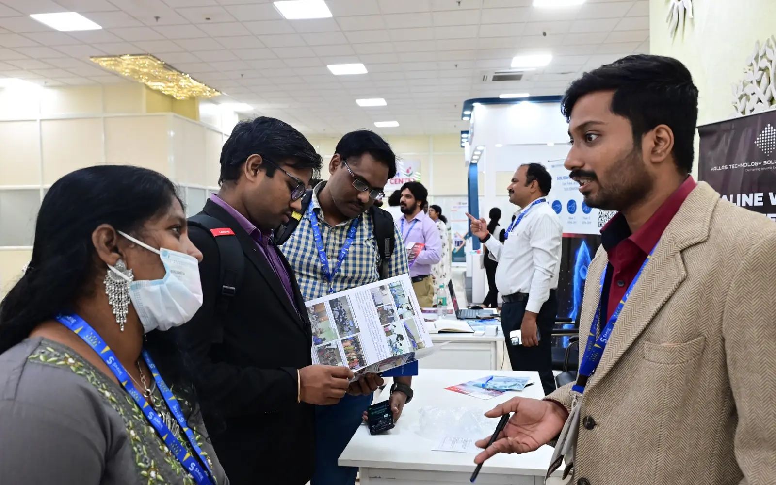 Participants examine and discuss technology at a SMilE Summit showcase